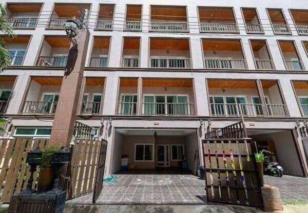 Luxurious 4-story Narai Place townhome in Pratumnak Soi 5 with modern exterior and lush surroundings.