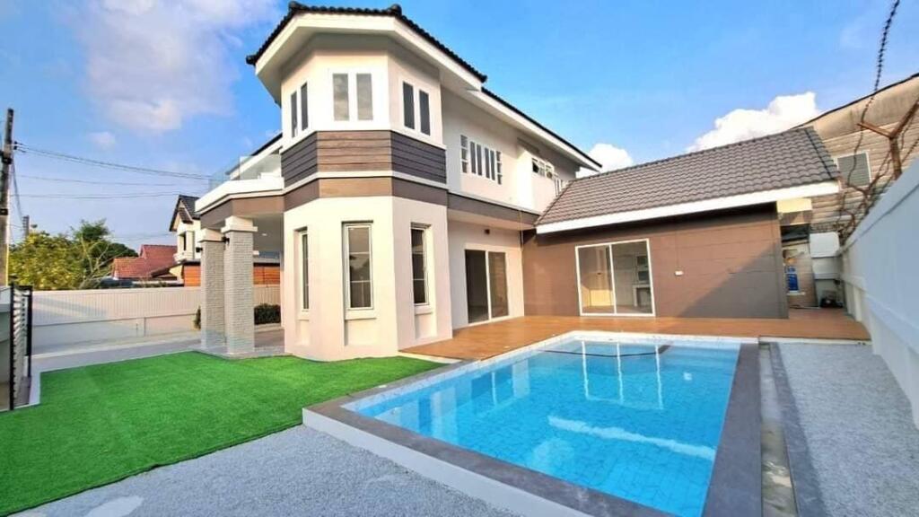 Exterior view of the luxurious pool villa in North Pattaya, showcasing modern architecture and lush landscaping.