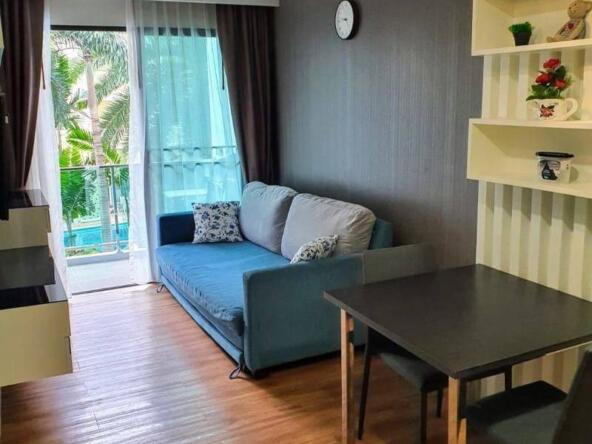 Interior of a modern 1-bedroom condo at Dusit Grand Park 1 in Pattaya, featuring stylish decor and city views.