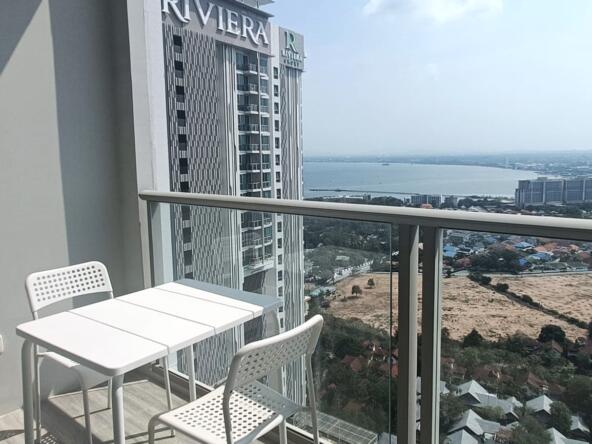 Interior view of a fully furnished studio on the 35th floor at Riviera Wongamat, featuring expansive city and sea views.