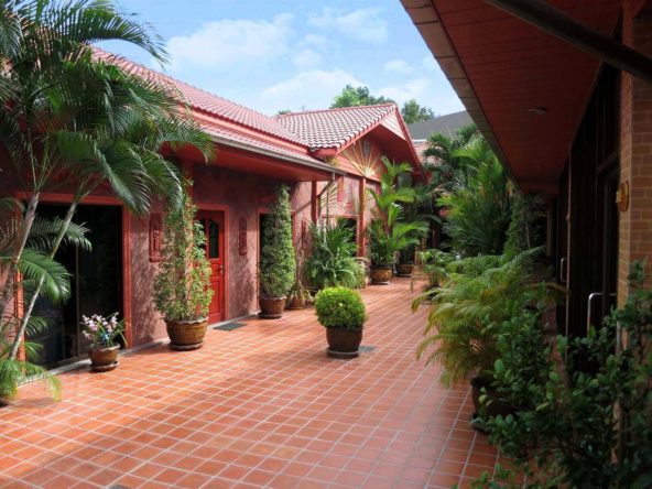 Aerial view of Pratumnak 8 Room Resort in Pattaya, showcasing the pool and lush garden surroundings.