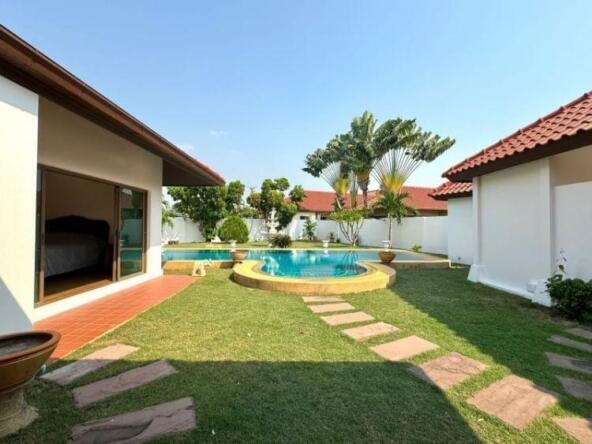 Luxurious Baan Balina 3 Pool Villa in Pattaya with lush gardens.