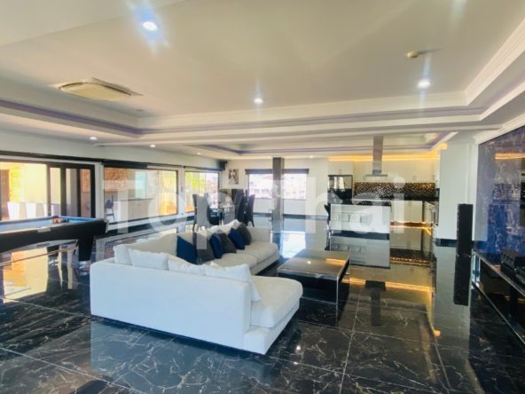 Luxurious penthouse in Pratumnak, Pattaya with expansive balcony and modern furnishings.
