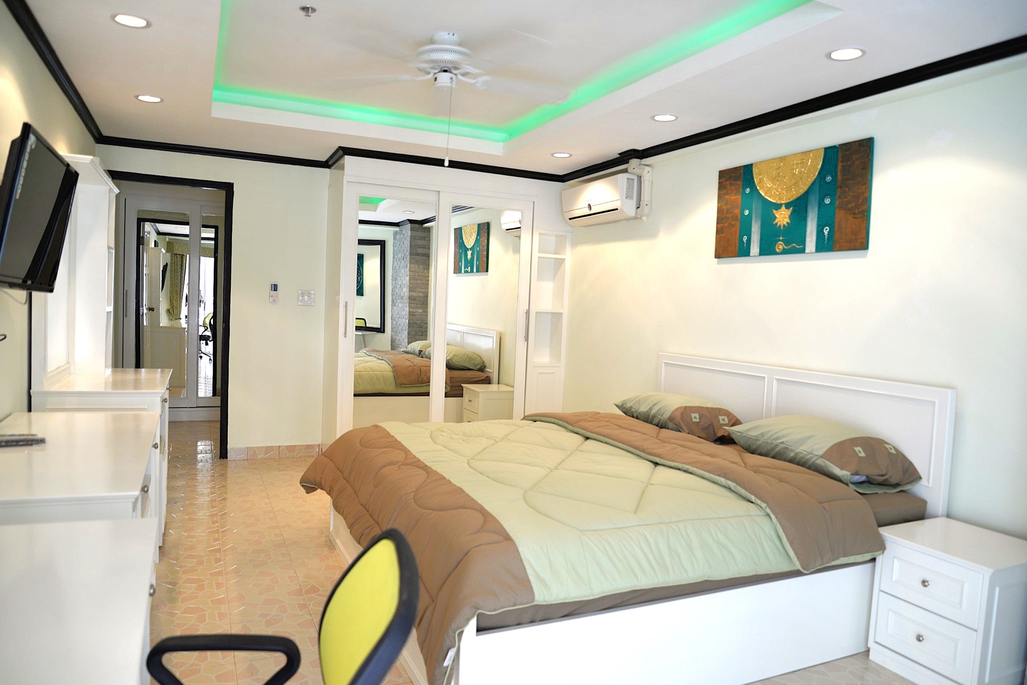 Spacious bedroom with large windows and modern decor at Jomtien Beach Condominium.