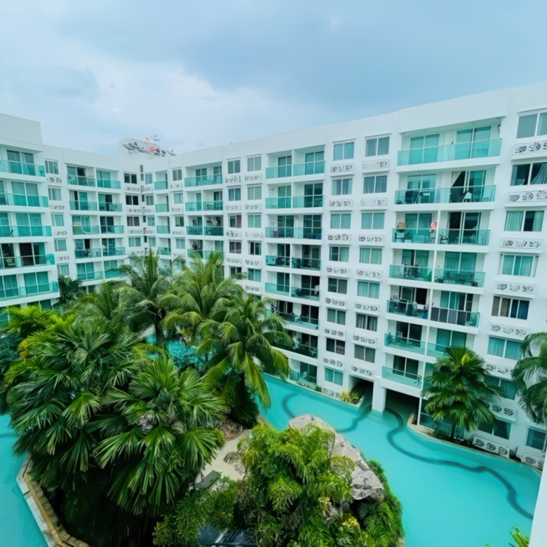 Modern furnished living room with balcony overlooking lagoon-style pool – Amazon Residence Jomtien